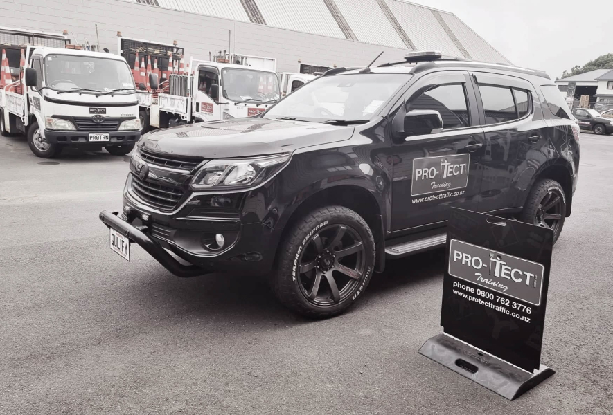 Pro-Tect yard featuring a black 4x4 with Pro-Tect branding on the door