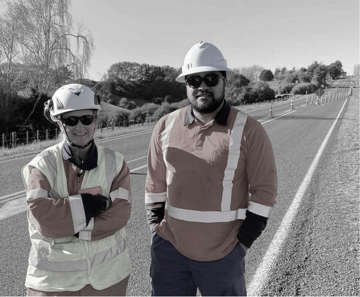 Pro-tect staff in safety gear standing on the side of the road